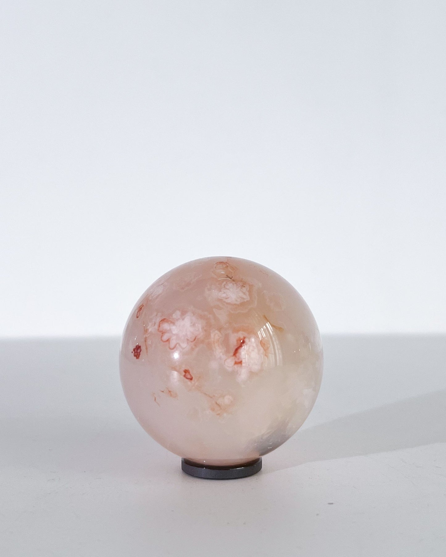 Studio photo of Hana showing subtle floral veining and soft, cloudy pink hues.