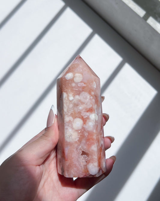 Close-up of white floral plumes and coral-toned layers on the crystal