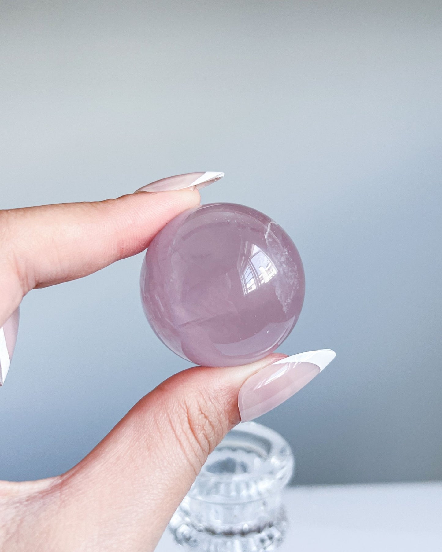Close-up of Girasol Rose Quartz sphere G showing clear surface and side foggy quartz clouding