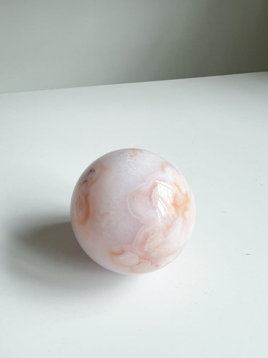 Carnelian Flower Agate sphere showing smooth swirls of pastel peach and light beige