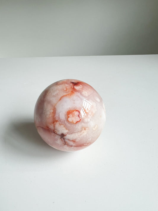 Carnelian Flower Agate sphere with peachy floral plume and coral blush patterns