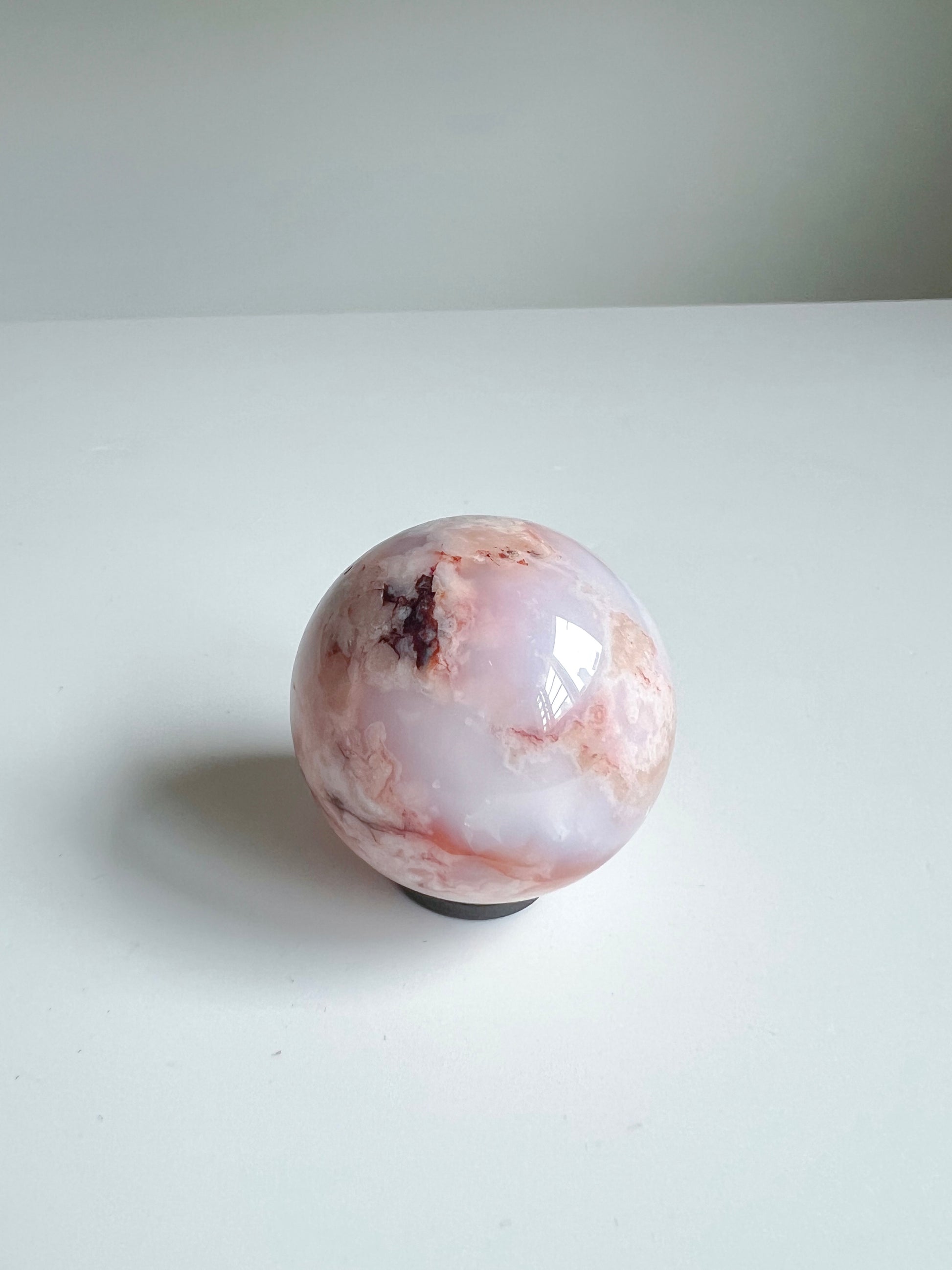 Carnelian Flower Agate sphere with dreamy milky blush tones and a soft burst of deep inclusions near the crown.
