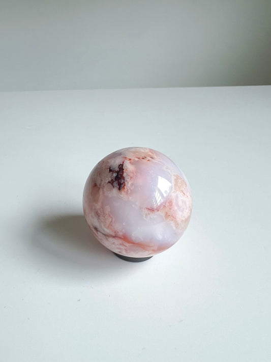 Carnelian Flower Agate sphere with dreamy milky blush tones and a soft burst of deep inclusions near the crown.