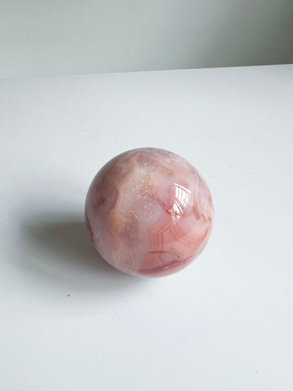 Carnelian Flower Agate sphere with peachy swirls and soft translucency — vibrant, calming, and full of inner joy.
