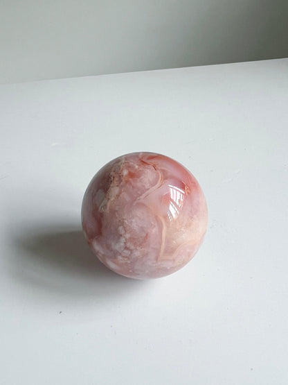 CFAS65-3 Softly lit Carnelian Flower Agate sphere with gentle movement in its marbling and delicate color shifts