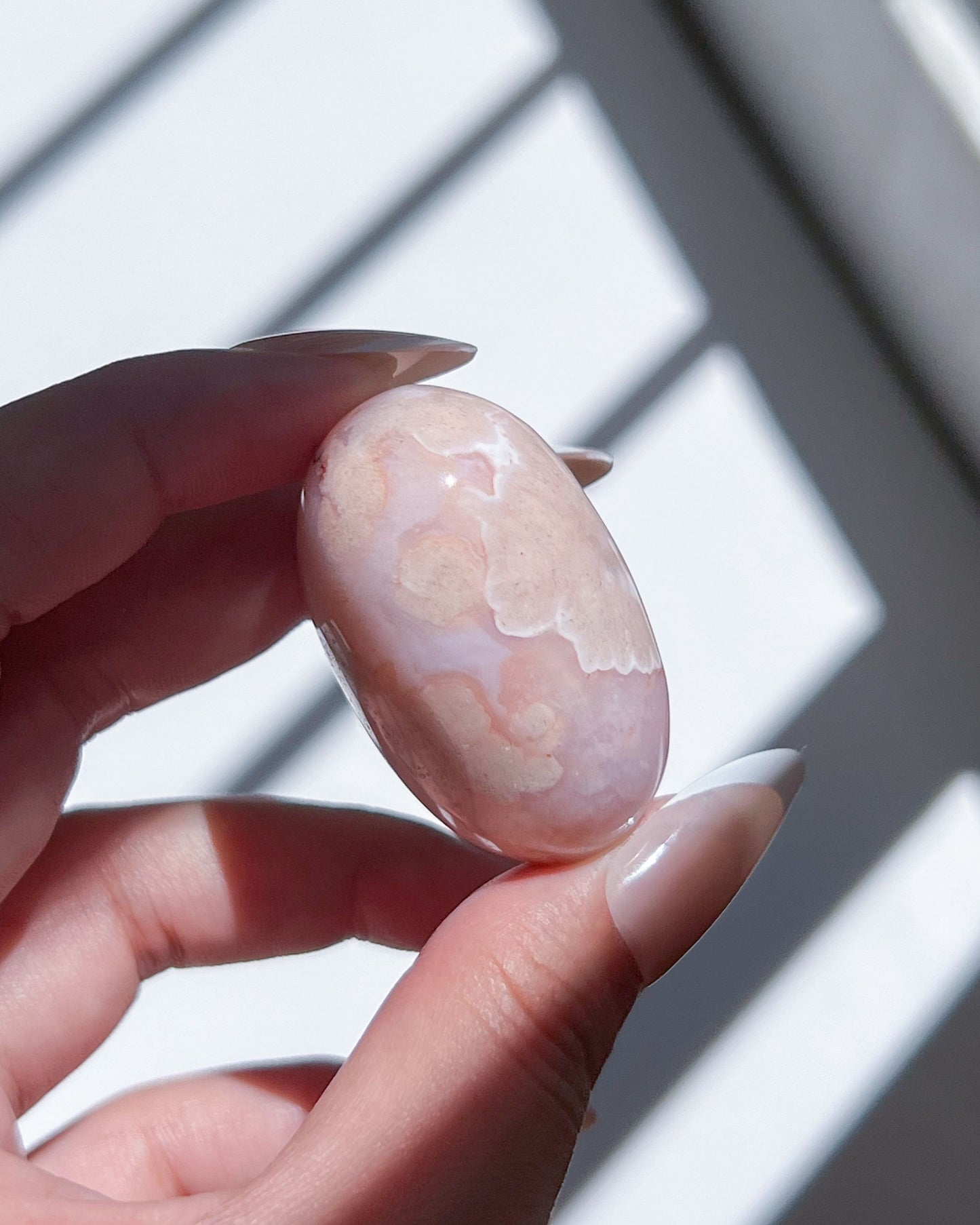 Carnelian Flower Agate Bean No. 10 — pastel pink crystal with soft floral plumes and dreamy banding.