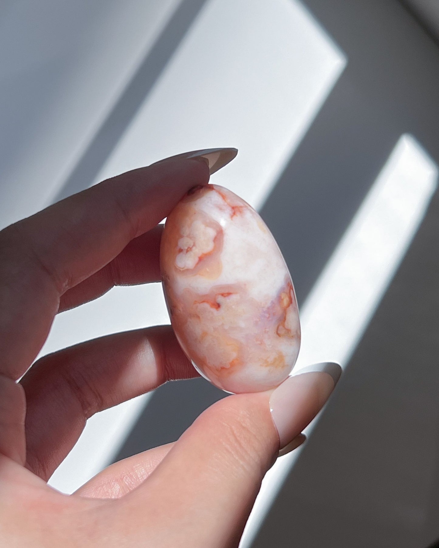 Carnelian Flower Agate Bean No. 13 — pastel pink crystal with soft floral plumes and dreamy banding.