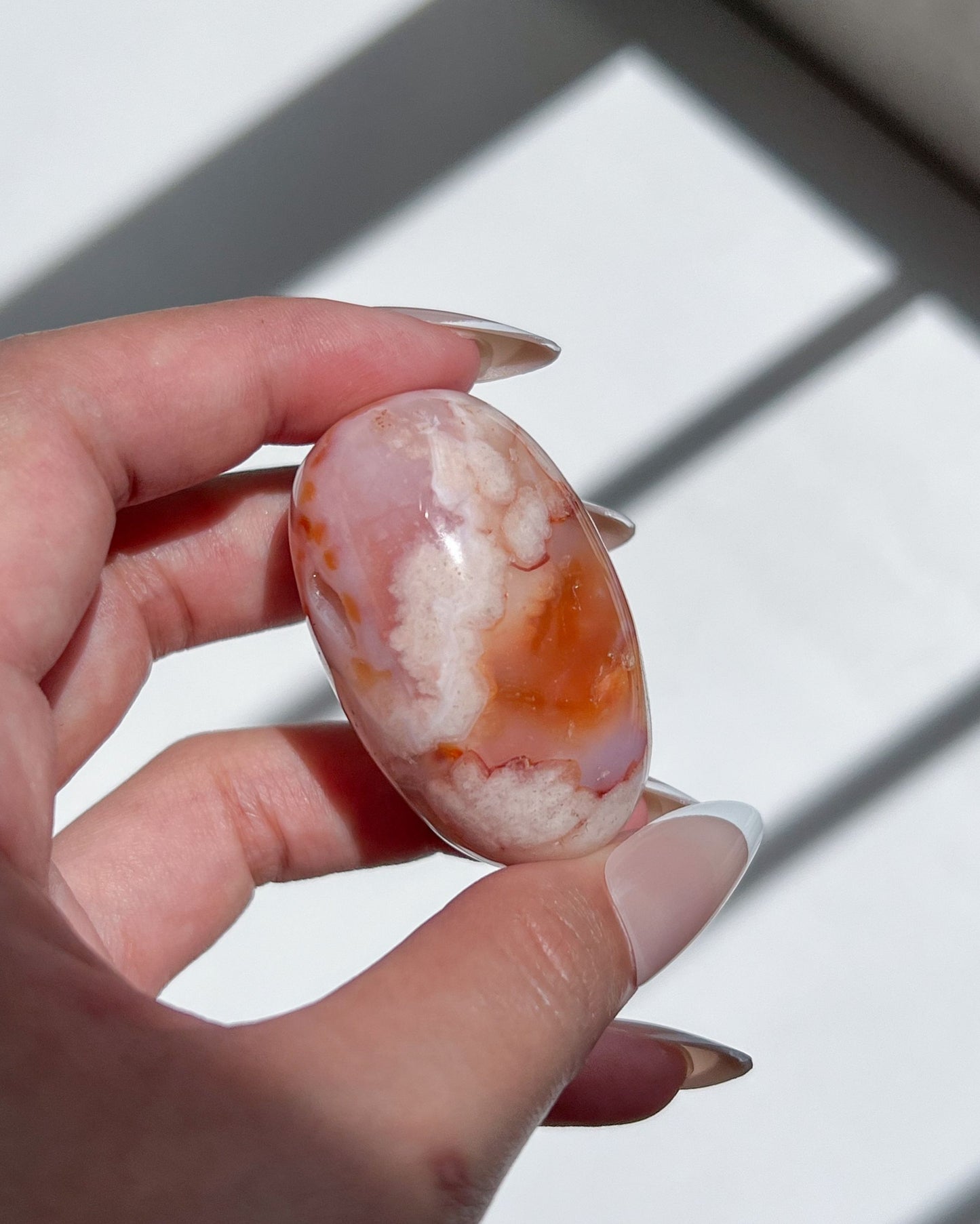 Bright orange-plumed Carnelian Flower Agate bean with candy-like swirls and translucent banding