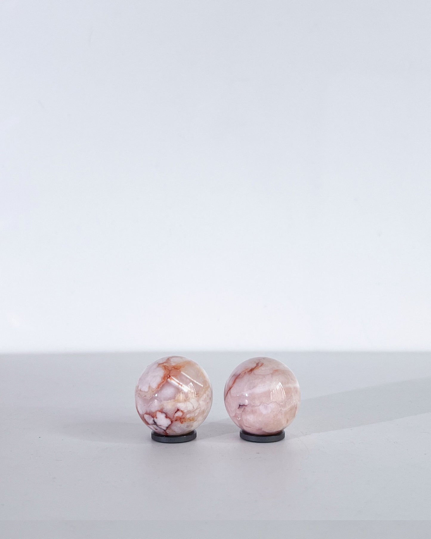 Back view of spheres showing peachy veins and soft pink-cream gradient banding.