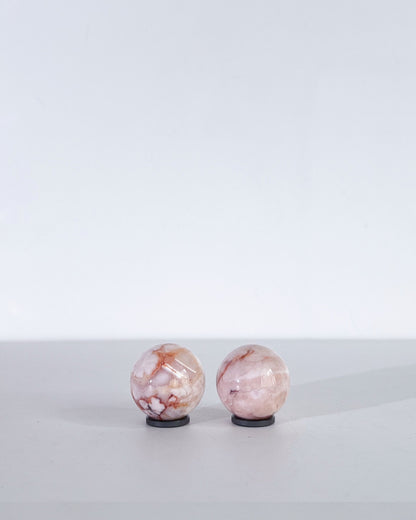 Back view of spheres showing peachy veins and soft pink-cream gradient banding.