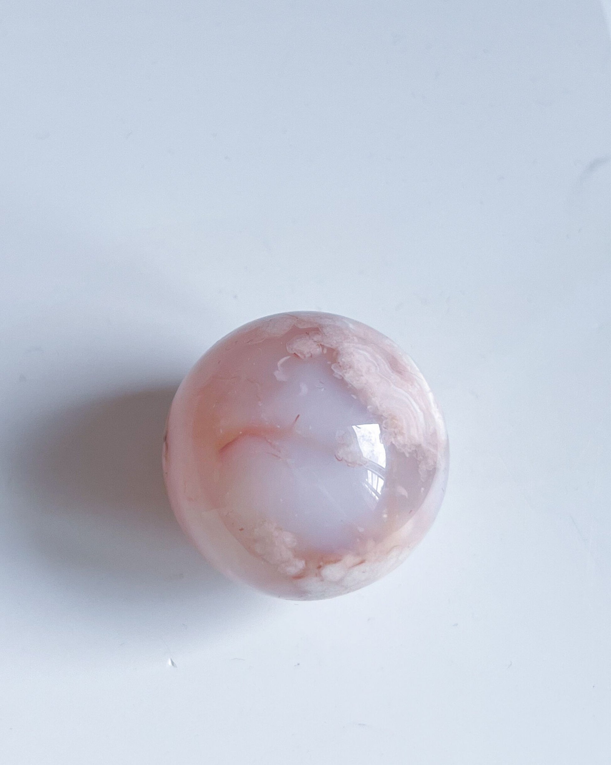 Top-down view of Sphere 10 Suki revealing gentle internal patterns and pastel banding