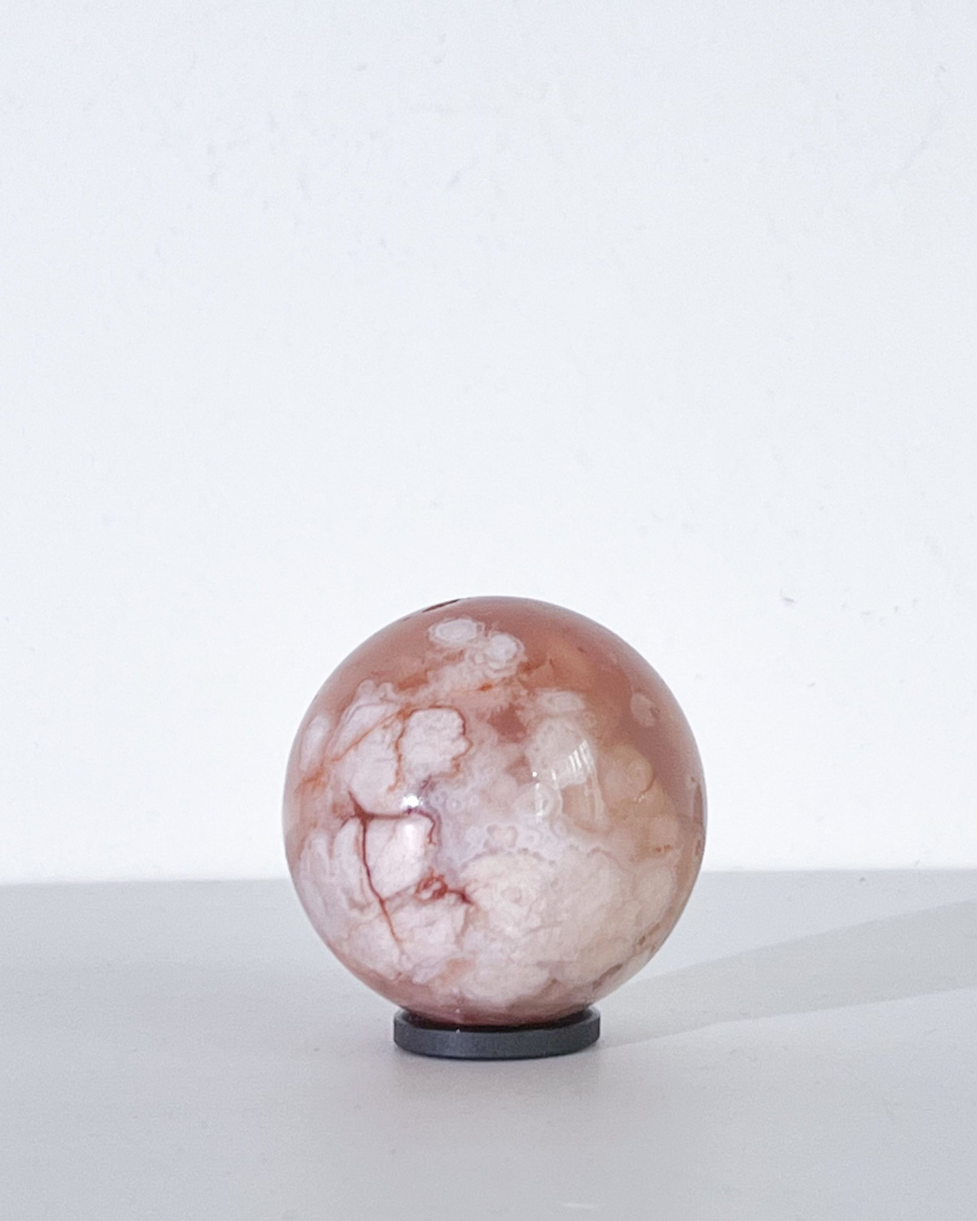 Right side of Sphere 11 showing dense creamy plumes with subtle streaks and light play on its polished surface

