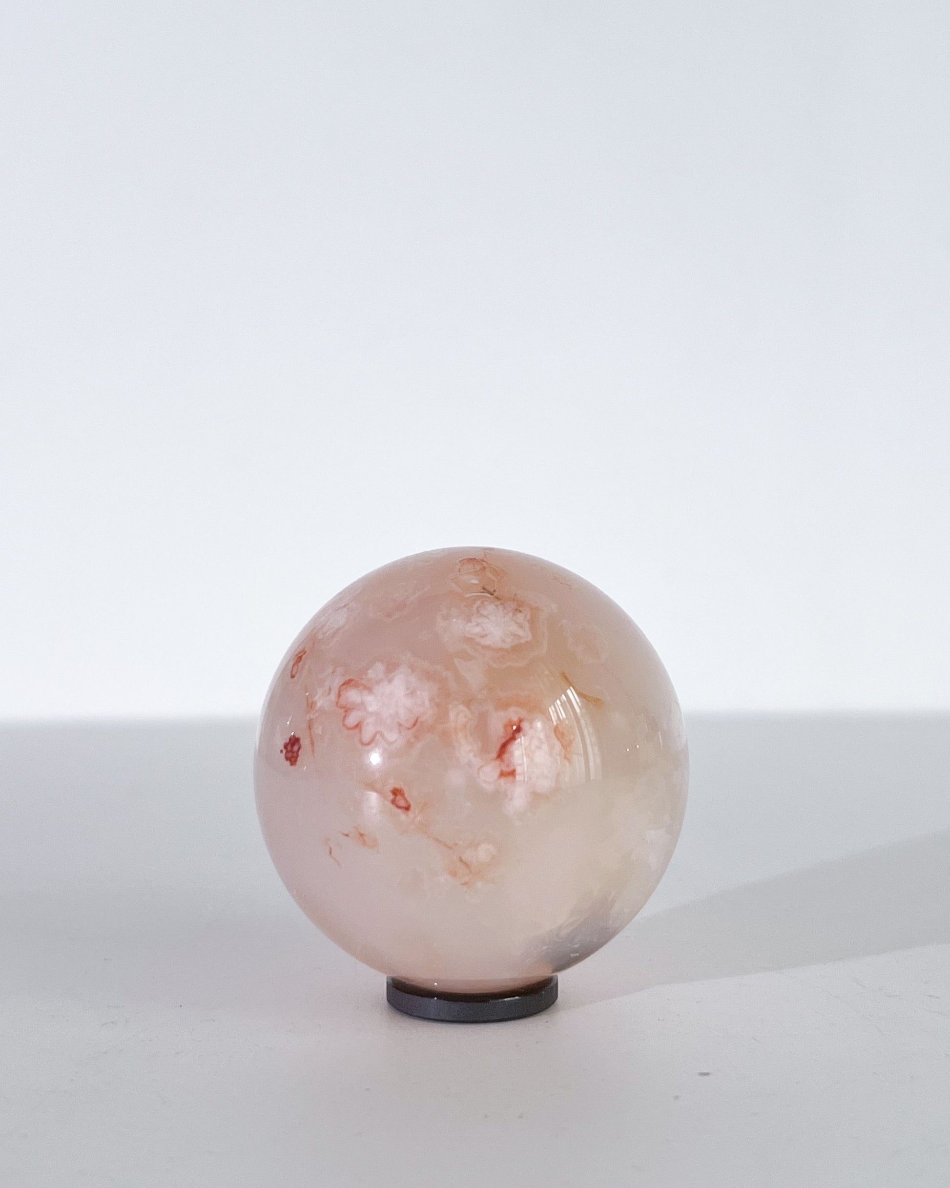 Studio photo of Hana showing subtle floral veining and soft, cloudy pink hues.