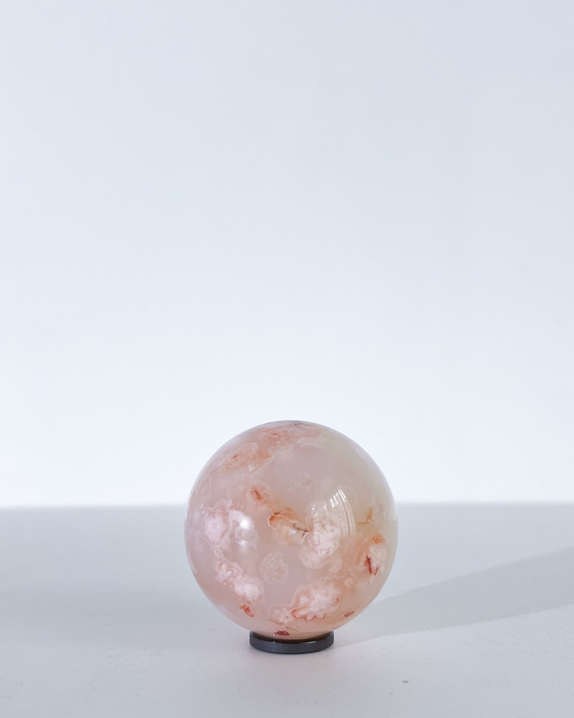 Clean product image of Hana, featuring a peachy surface with faint white blooms.