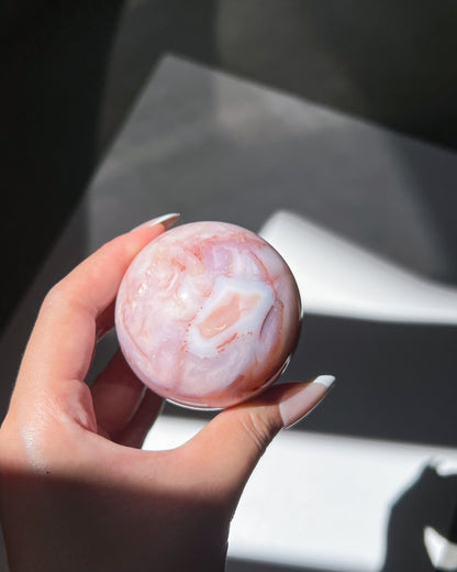 Handheld shot of Claude showing soft blush gradients and diffused lavender inclusions.