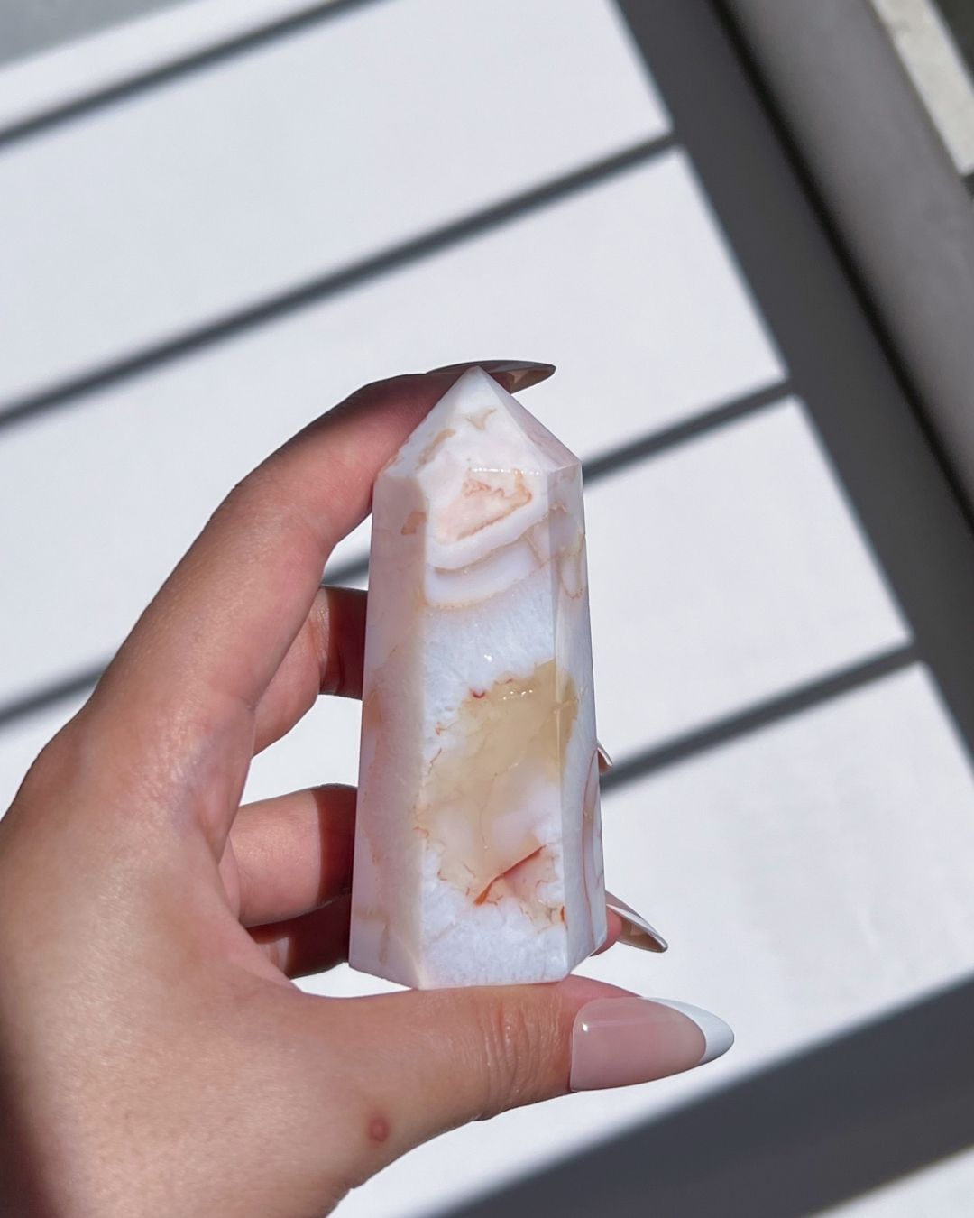 Angled view of tower with prominent light peach veining and creamy banding