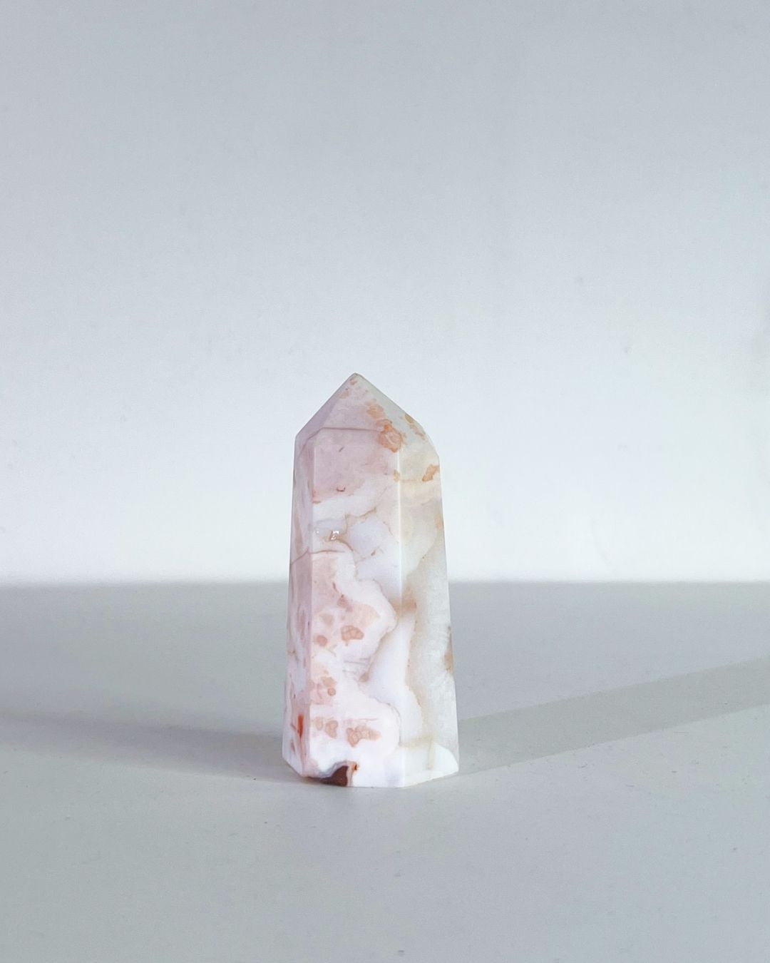 Full tower shot against a clean white background showing soft florals and layering