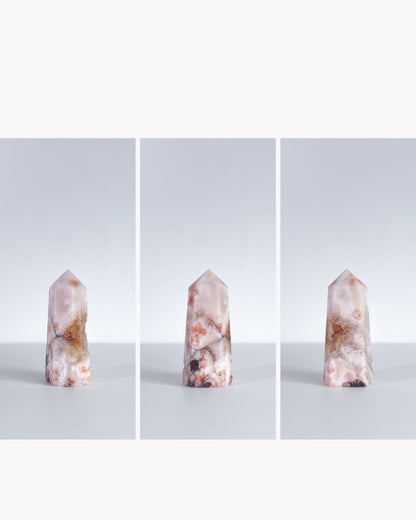 Trio display of the same Carnelian Flower Agate tower in clean editorial style