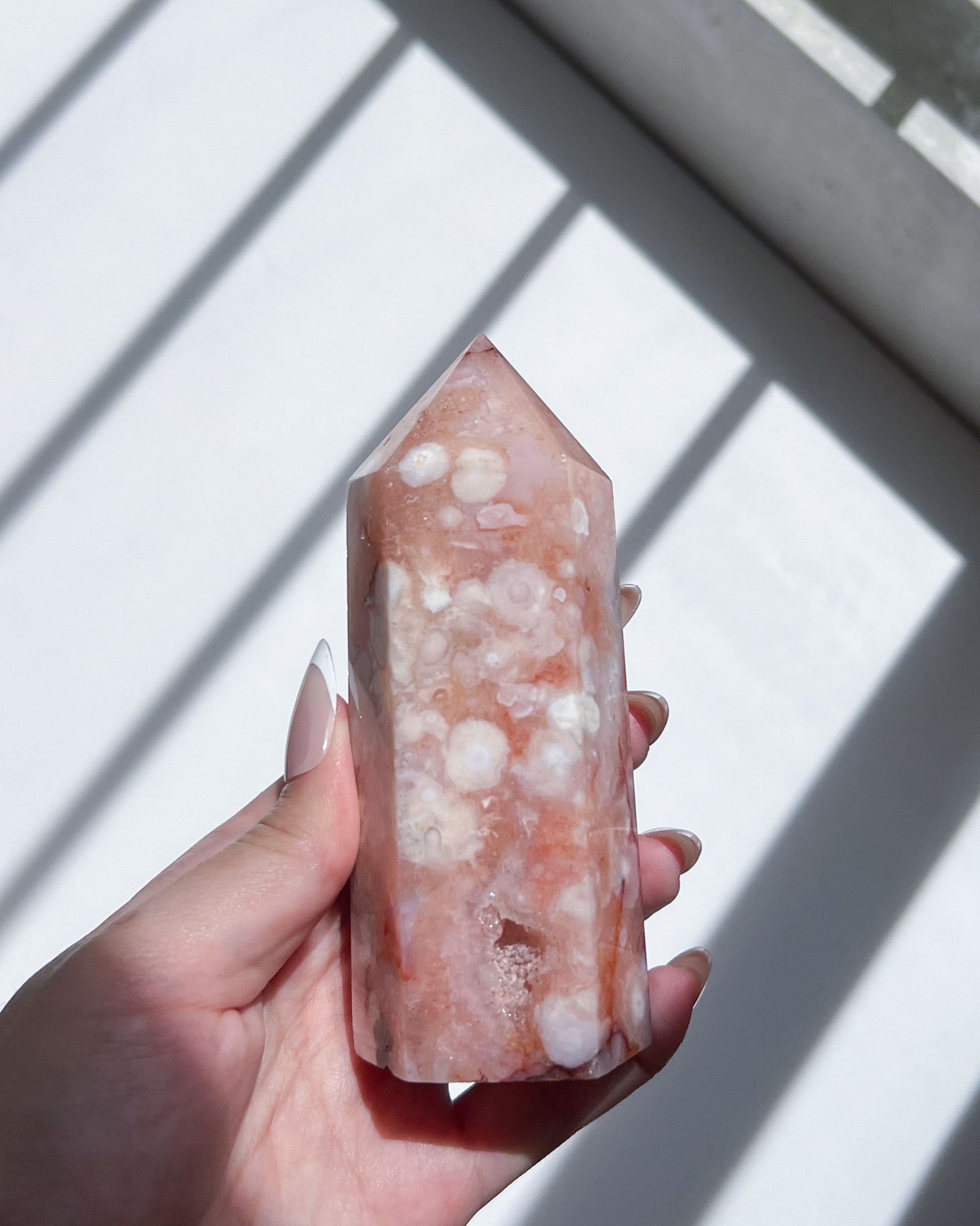 Close-up of white floral plumes and coral-toned layers on the crystal