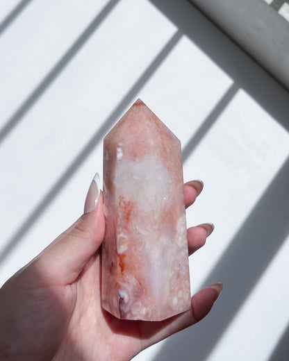 Angled handheld shot of the carnelian flower agate, highlighting the heart-shaped spot and mist-like swirls