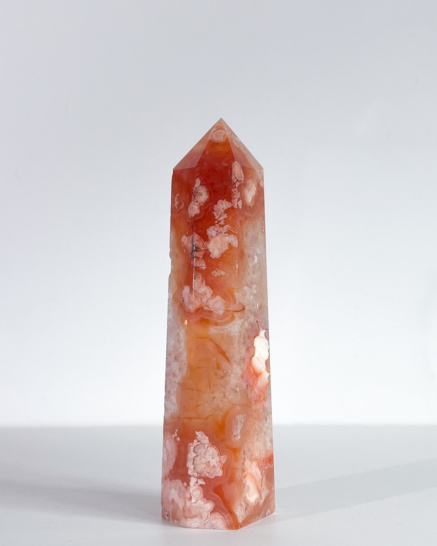 Saffron tower viewed from the side, revealing blooming floral plumes and quartz formations
