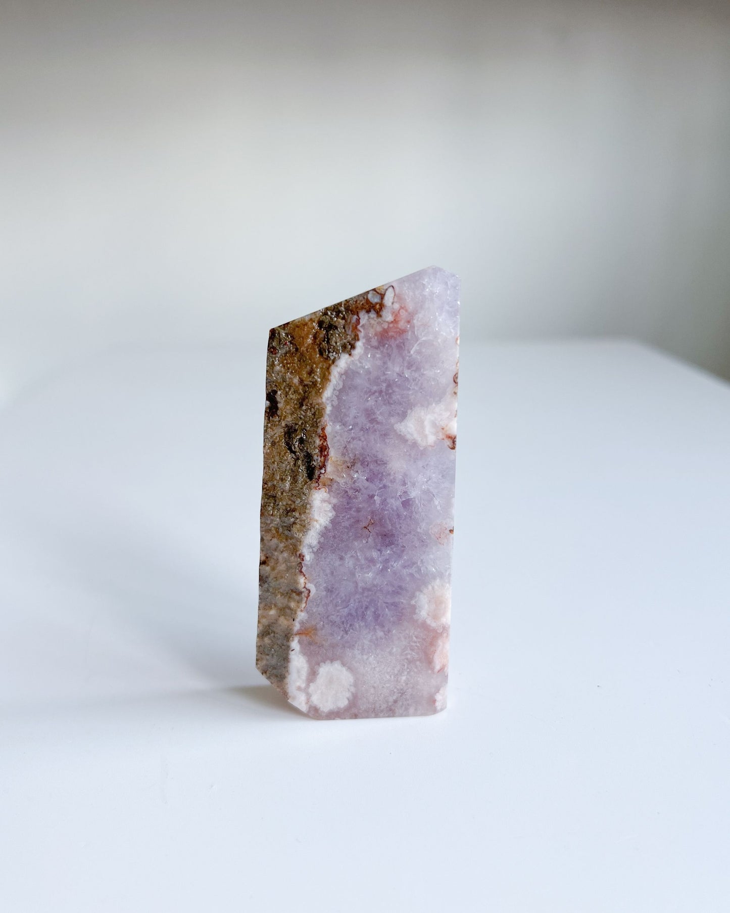 Back of Leia flower agate slab showcasing earthy quartz ridge and pinkish floral blooms