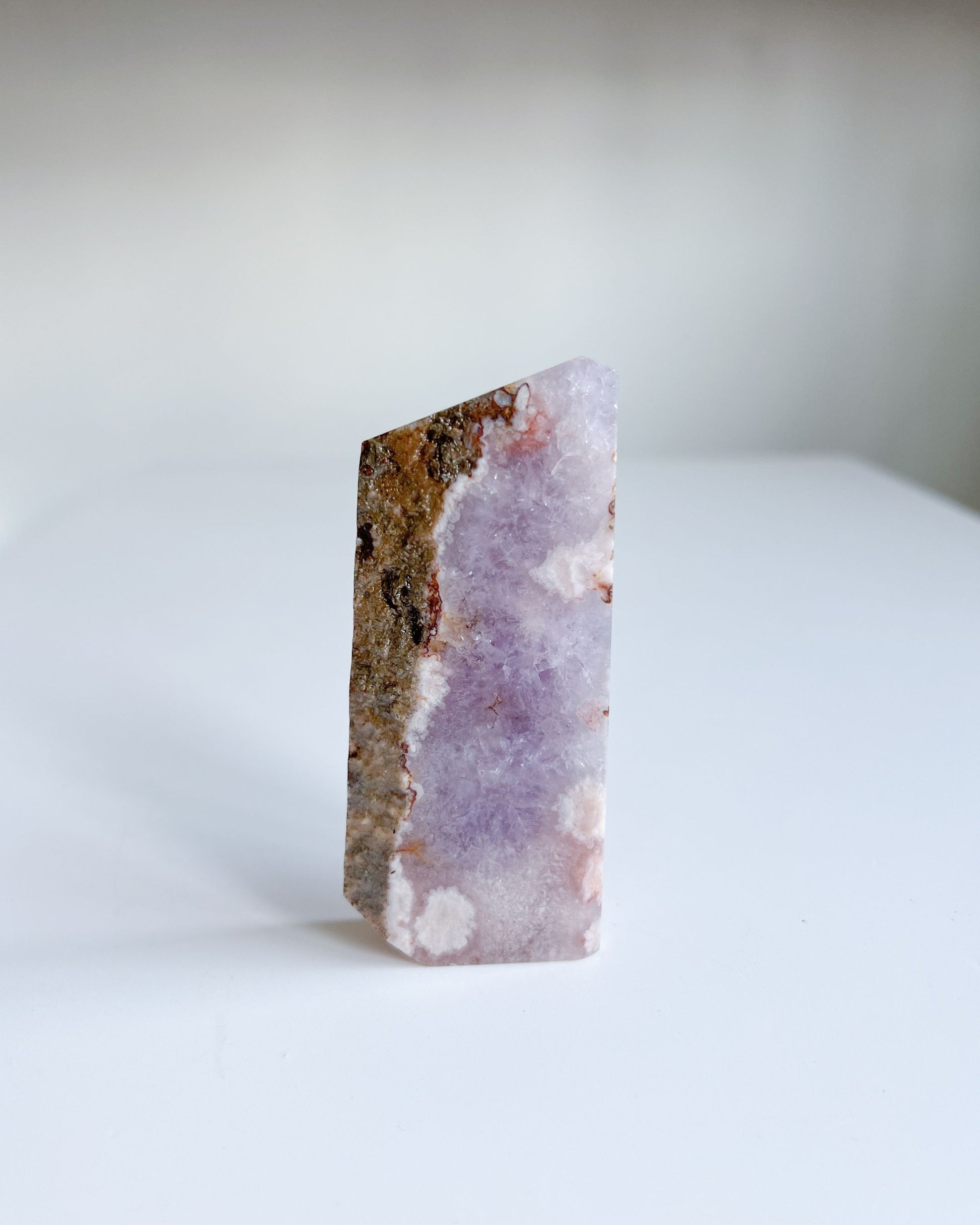 Back of Leia flower agate slab showcasing earthy quartz ridge and pinkish floral blooms