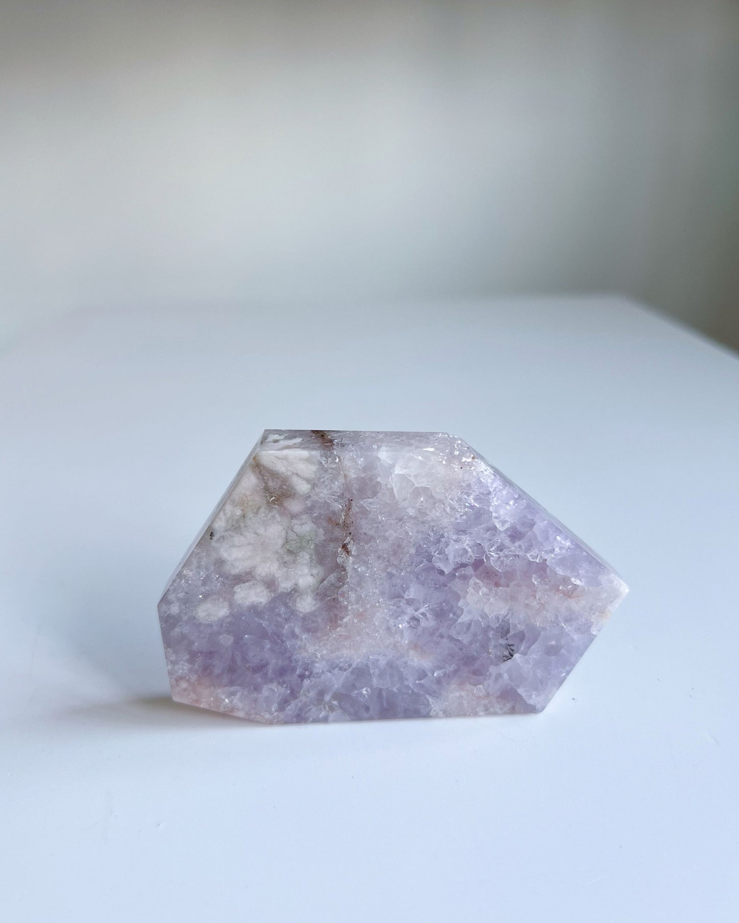 Front view of Faye slab self standing, highlighting green sakura inclusions and soft lilac