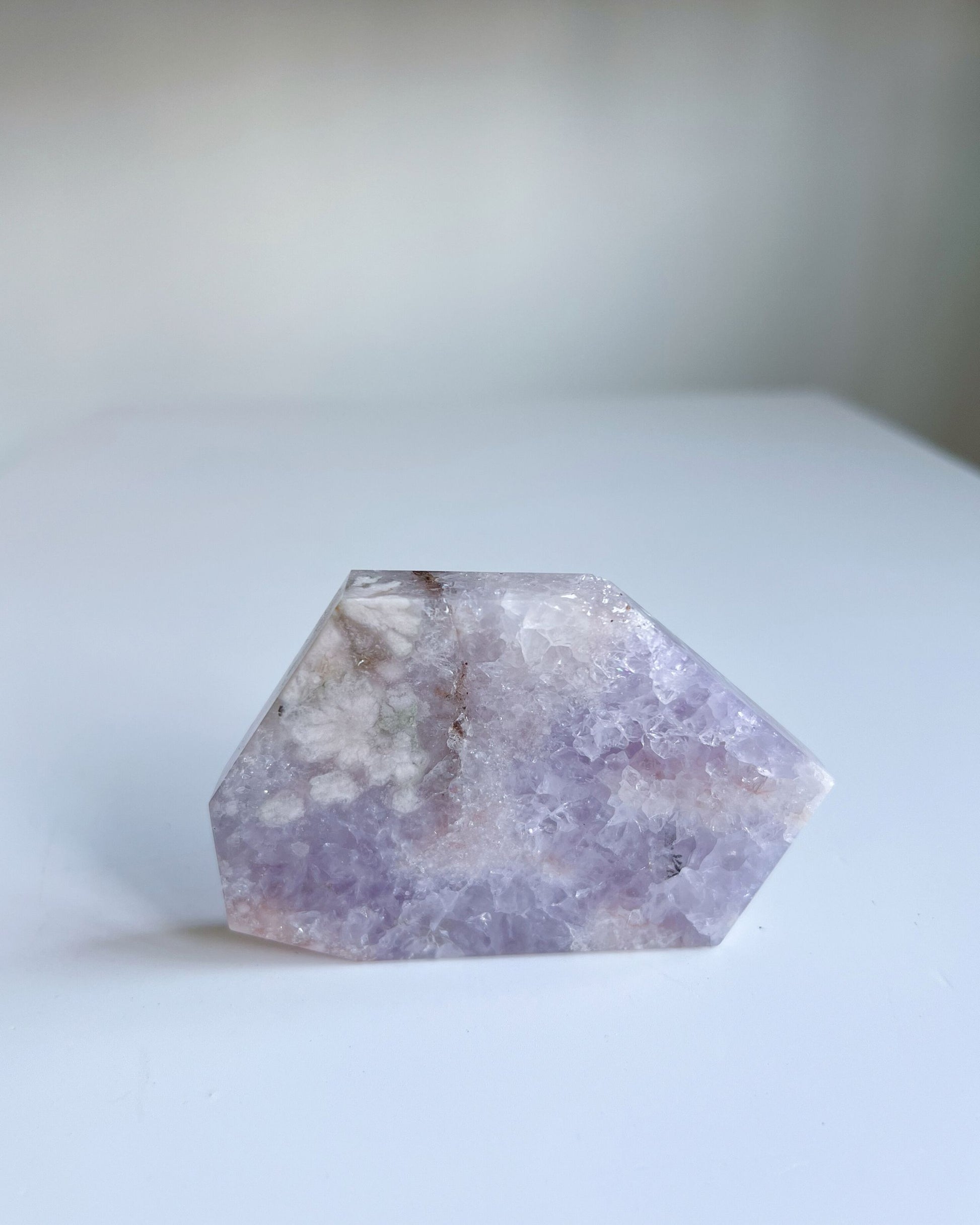 Front view of Faye slab self standing, highlighting green sakura inclusions and soft lilac