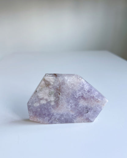 Front view of Faye slab self standing, highlighting green sakura inclusions and soft lilac