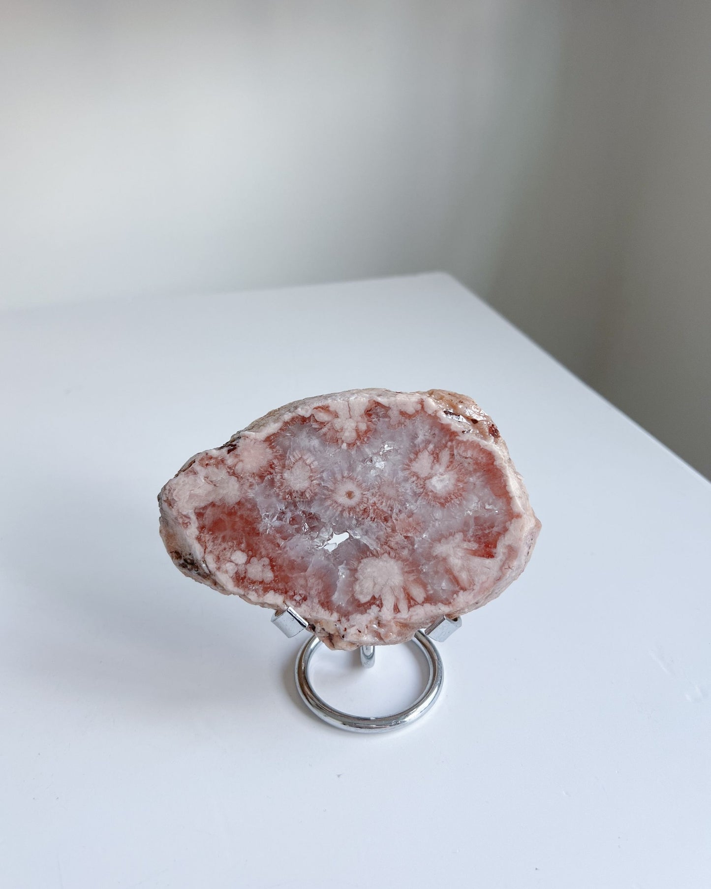 Juliette Flower Agate upright on metal stand in minimal daylight setting