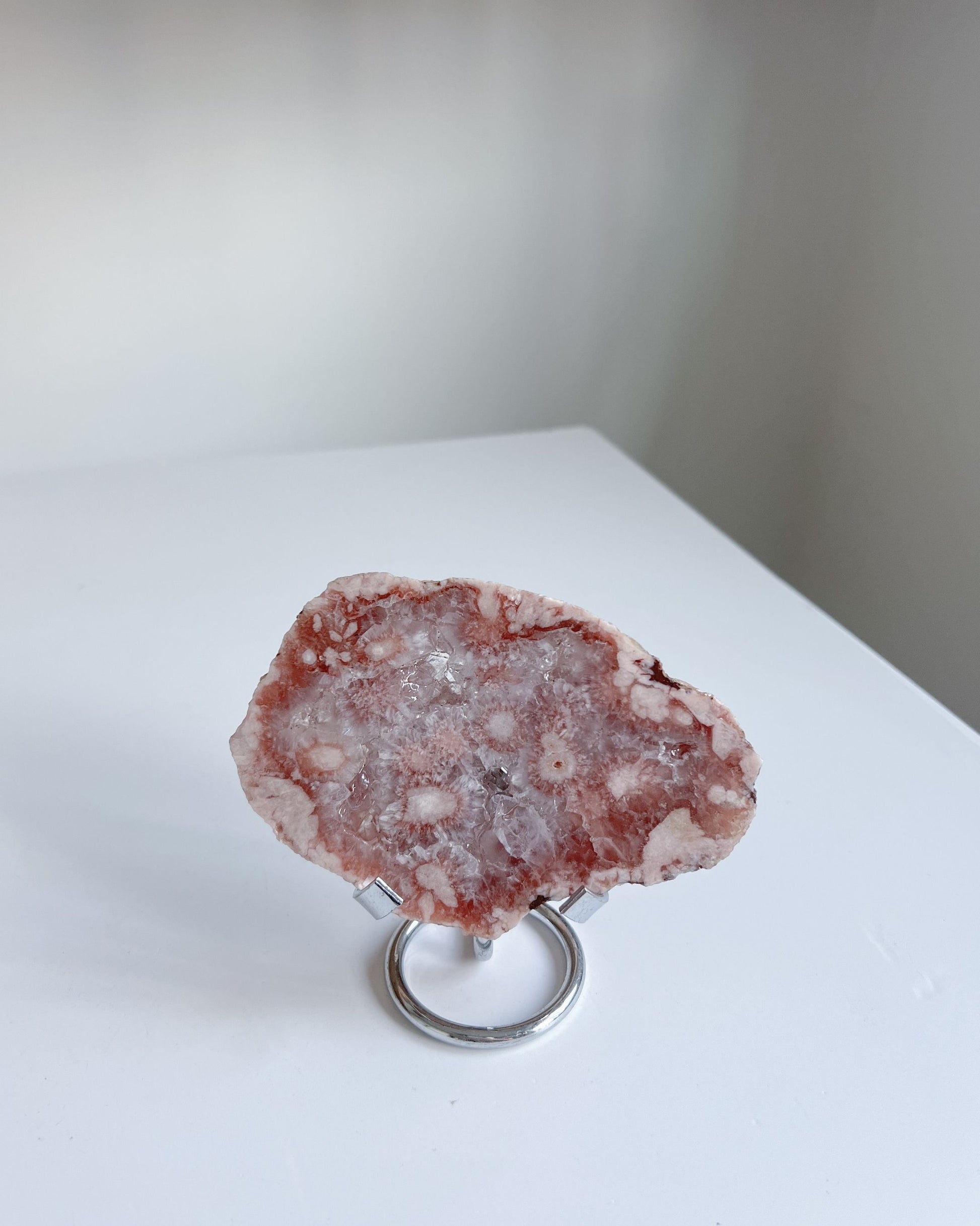 Pink and lavender-toned Flower Agate slab displayed with soft shadows and shimmer