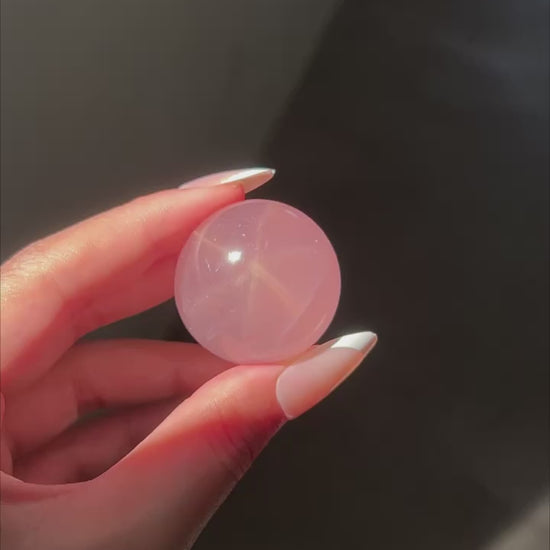 Deep Pink Rose Quartz Sphere under sunlight, flashlight and studio lighting, revealing rainbows and asterism
