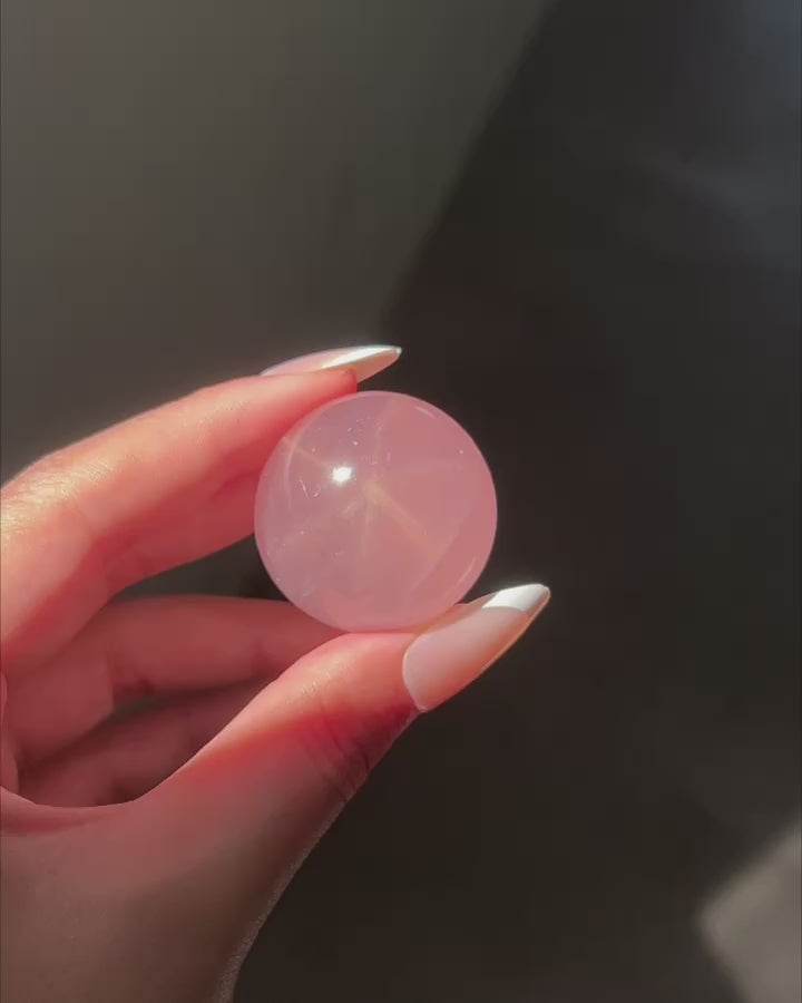Deep Pink Rose Quartz Sphere under sunlight, flashlight and studio lighting, revealing rainbows and asterism