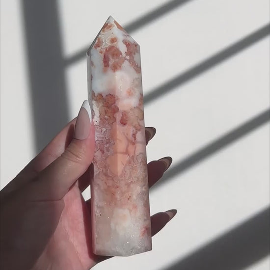 Video of Hand holding a Sakura Carnelian Flower Agate tower