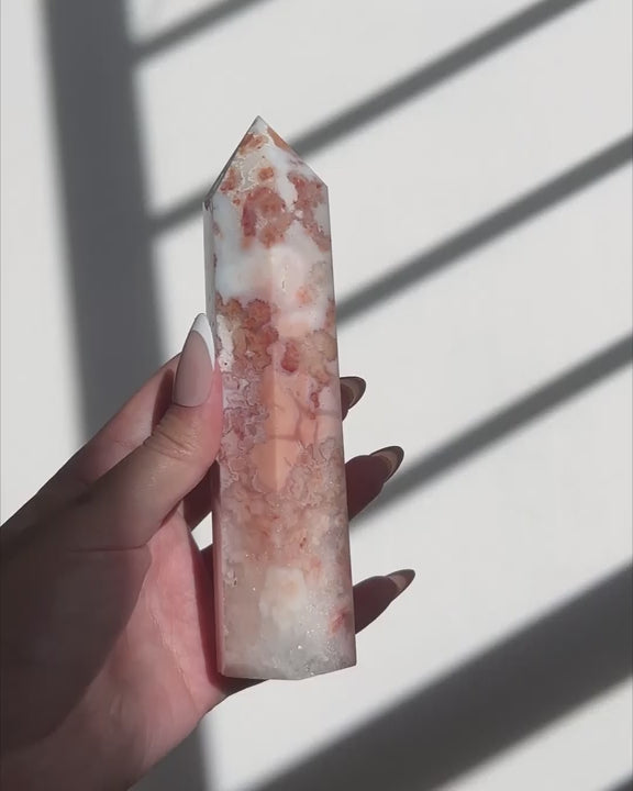 Video of Hand holding a Sakura Carnelian Flower Agate tower