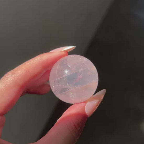 Light Pink Girasol Rose Quartz Sphere under sunlight, flashlight and studio lighting, revealing clarity and asterism