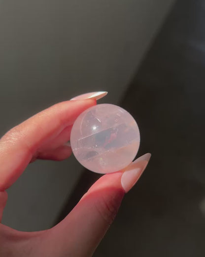 Light Pink Girasol Rose Quartz Sphere under sunlight, flashlight and studio lighting, revealing clarity and asterism
