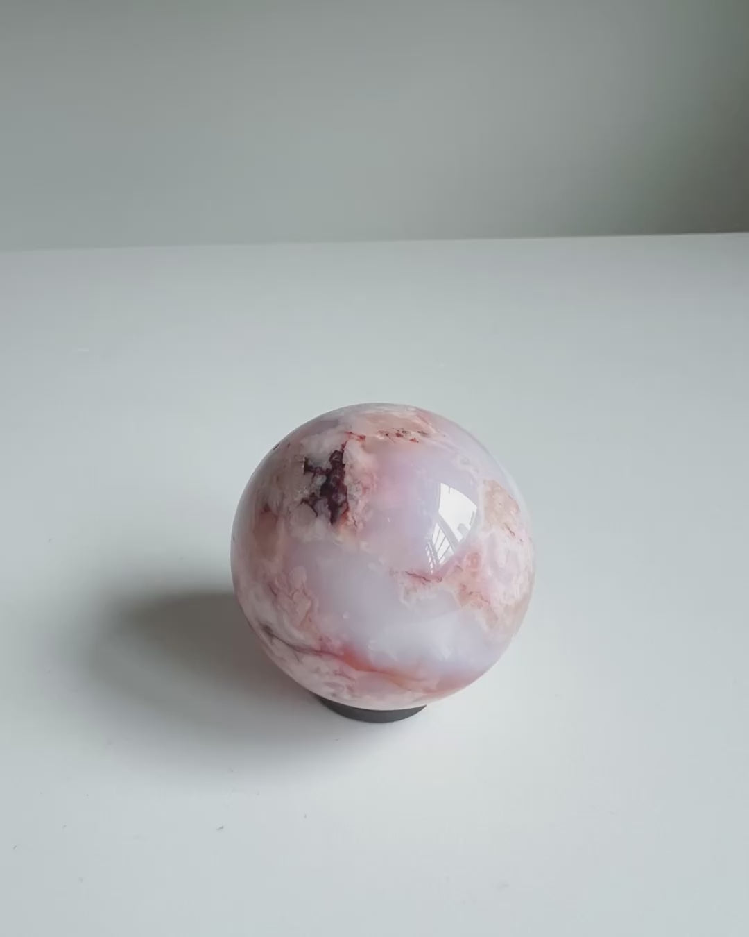 Video of a creamy blue and red toned Carnelian Flower Agate Sphere 46A