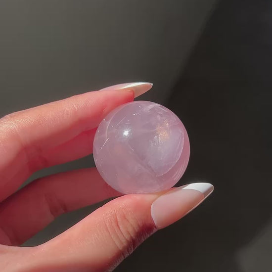 Lavender Pink Rose Quartz Sphere under sunlight, flashlight and studio lighting, revealing rainbows and asterism