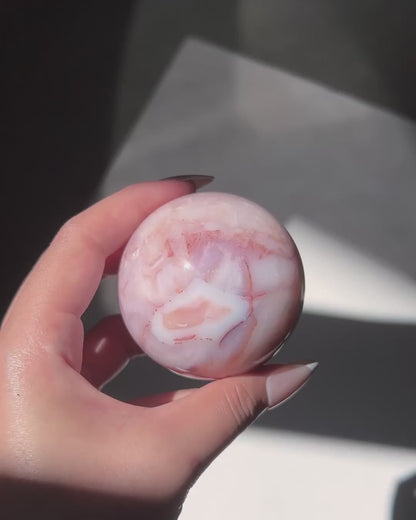 Video of Carnelian Agate Sphere Claude in sunlight.